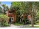 Charming two-story home with a terracotta facade, lush landscaping, and unique arched windows at 602 E Livingston St # 3, Orlando, FL 32803