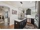 Modern kitchen with stainless steel appliances, black cabinetry, quartz countertops, and gas cooktop island at 602 E Livingston St # 3, Orlando, FL 32803