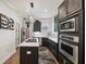 Well-appointed kitchen featuring modern appliances, black cabinetry, quartz countertops, and gas cooktop island at 602 E Livingston St # 3, Orlando, FL 32803