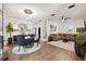 Open-concept living and dining area with stylish furnishings and modern lighting at 602 E Livingston St # 3, Orlando, FL 32803