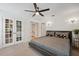 Stylish main bedroom featuring a ceiling fan, neutral color palette, and French doors to the closet at 602 E Livingston St # 3, Orlando, FL 32803