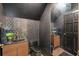Stylish powder room featuring triangle mosaic wall tiles, floating wood vanity, and sleek black fixtures at 602 E Livingston St # 3, Orlando, FL 32803