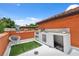 Roof deck featuring an outdoor kitchen with barbecue and orange stucco wall at 602 E Livingston St # 3, Orlando, FL 32803