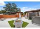 This spacious roof deck features seating areas and a vibrant orange stucco wall at 602 E Livingston St # 3, Orlando, FL 32803