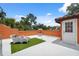 A roof deck with orange walls, white floors, and wicker seating at 602 E Livingston St # 3, Orlando, FL 32803