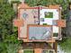 Aerial view of a rooftop patio featuring outdoor seating, greenery, and tile roofing at 602 E Livingston St # 3, Orlando, FL 32803