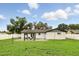 Expansive backyard with a patio area, modern pergola, and well-maintained lawn, ideal for entertaining and relaxation at 7307 Grace Rd, Orlando, FL 32819