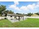 Spacious backyard featuring a pergola, patio, lush lawn and a white fence, perfect for outdoor living at 7307 Grace Rd, Orlando, FL 32819
