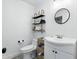 Bathroom with stylish vanity, modern fixtures, and decorative shelves at 7307 Grace Rd, Orlando, FL 32819