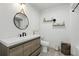 Bathroom features wood-look floors, stylish vanity, wall decorations, and black fixtures at 7307 Grace Rd, Orlando, FL 32819