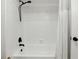 Bright bathroom showing a white tub and shower with black fixtures and white subway tiles at 7307 Grace Rd, Orlando, FL 32819