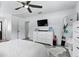 Bedroom with light gray wood floors, dresser, ceiling fan and a large window at 7307 Grace Rd, Orlando, FL 32819