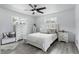 Cozy bedroom features light gray wood floors, natural light and stylish decor at 7307 Grace Rd, Orlando, FL 32819