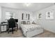 Bright bedroom featuring wood-look floors, white walls and trim, and windows that provide natural light at 7307 Grace Rd, Orlando, FL 32819