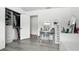 Bright bedroom featuring wood-look floors, vanity, a closet, and white walls at 7307 Grace Rd, Orlando, FL 32819