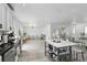 Bright, open-concept kitchen with white cabinets, stainless steel appliances, and eat-in kitchen island at 7307 Grace Rd, Orlando, FL 32819