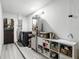 Spacious laundry room featuring a washer and dryer, wood-look flooring, and storage shelves at 7307 Grace Rd, Orlando, FL 32819