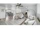 Open living space with hardwood floors, comfortable seating, and an adjacent kitchen area at 7307 Grace Rd, Orlando, FL 32819