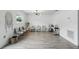 Bright living space with stylish light fixture, wood floors, and comfortable seating at 7307 Grace Rd, Orlando, FL 32819