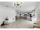 Open-concept layout showcases kitchen, living area, and dining area with wood floors and natural light at 7307 Grace Rd, Orlando, FL 32819
