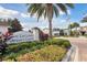 Community amenity center with lush landscaping, palm trees, and inviting architecture on a bright, sunny day at 746 Longboat Dr, Davenport, FL 33896