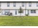 Well-maintained backyard featuring a grassy lawn and patio seating, ideal for outdoor enjoyment at 746 Longboat Dr, Davenport, FL 33896