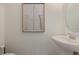 Modern powder room with a pedestal sink and minimalist decor at 746 Longboat Dr, Davenport, FL 33896
