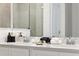 Bathroom featuring double vanity, framed mirrors, and tiled shower at 746 Longboat Dr, Davenport, FL 33896
