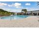 Large community pool with ample deck space, lounge chairs, and umbrellas for a relaxing experience at 746 Longboat Dr, Davenport, FL 33896
