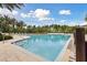 Inviting community pool with a gradual entry, surrounded by lush landscaping and comfortable lounge areas at 746 Longboat Dr, Davenport, FL 33896