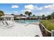 Large, inviting pool area with lounge chairs, umbrellas, and a beautifully designed pool house for residents at 746 Longboat Dr, Davenport, FL 33896