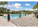 Community pool area showcasing a spacious deck, inviting blue waters, and comfortable lounge areas for relaxation at 746 Longboat Dr, Davenport, FL 33896