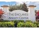 Community sign for 'The Enclaves Amenity Center' surrounded by lush landscaping showcasing a welcoming atmosphere at 746 Longboat Dr, Davenport, FL 33896