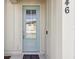 Charming entryway featuring a light blue door with glass panel and modern hardware, creating a welcoming entrance at 746 Longboat Dr, Davenport, FL 33896