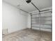 Spacious garage offering ample storage with white walls, an automatic garage door and a gray concrete floor at 746 Longboat Dr, Davenport, FL 33896