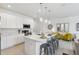 Bright kitchen featuring a quartz island with pendant lights and modern stainless steel appliances at 746 Longboat Dr, Davenport, FL 33896