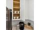 Coffee station inside of a white kitchen cabinet with mugs neatly placed on shelves at 746 Longboat Dr, Davenport, FL 33896
