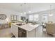 Bright open-concept kitchen overlooking the living and dining areas, featuring a modern island at 746 Longboat Dr, Davenport, FL 33896
