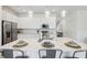Modern kitchen with white cabinets, stainless steel appliances, and a spacious island for meal preparation at 746 Longboat Dr, Davenport, FL 33896