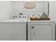 Well-organized laundry room with washer, dryer, and ample shelving at 746 Longboat Dr, Davenport, FL 33896