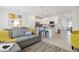 Inviting living space with a comfortable gray sofa, a dining area, and an open-concept kitchen at 746 Longboat Dr, Davenport, FL 33896