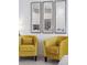Interior view showcasing stylish yellow chairs, mirrors, and glimpse of open floor plan and kitchen at 746 Longboat Dr, Davenport, FL 33896