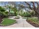 Beautifully landscaped mini golf course with mature trees and winding walkways throughout the outdoor space at 746 Longboat Dr, Davenport, FL 33896