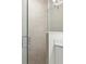 Bathroom shower with a large shower head, modern tile, and glass door at 746 Longboat Dr, Davenport, FL 33896