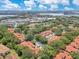 A beautiful aerial view of the community with lush landscaping and terra cotta roofs, near the lake and shopping center at 8035 Bayside View Dr, Orlando, FL 32819
