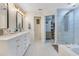 Bright bathroom featuring a double sink vanity, tiled floors, and glass enclosed shower at 8035 Bayside View Dr, Orlando, FL 32819