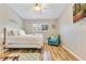 Inviting bedroom with luxury hardwood floors, ceiling fan, wall-mounted television and chair at 8035 Bayside View Dr, Orlando, FL 32819