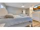 Spacious bedroom boasts wood floors, ceiling fan, plantation shutters, and dresser with TV at 8035 Bayside View Dr, Orlando, FL 32819