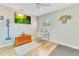 Bright bedroom with hard wood floors, ceiling fan, desk and chair, and wall-mounted television at 8035 Bayside View Dr, Orlando, FL 32819
