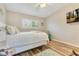 Inviting bedroom with hardwood floors, ceiling fan, wall-mounted television and relaxing chair at 8035 Bayside View Dr, Orlando, FL 32819